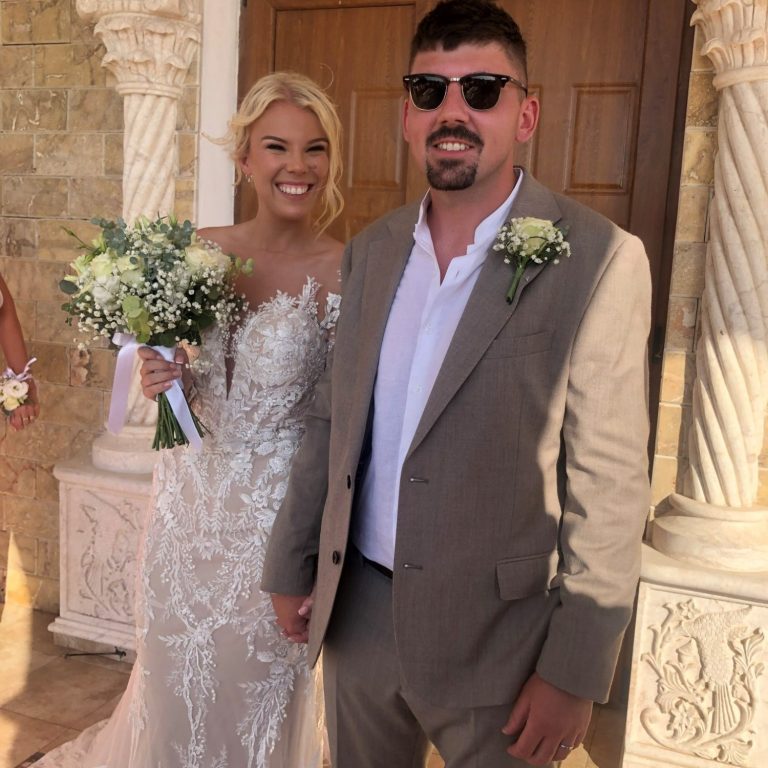 Happy couple standing outside the church after tying the knot, officiated by Molly's Ceremonies.
