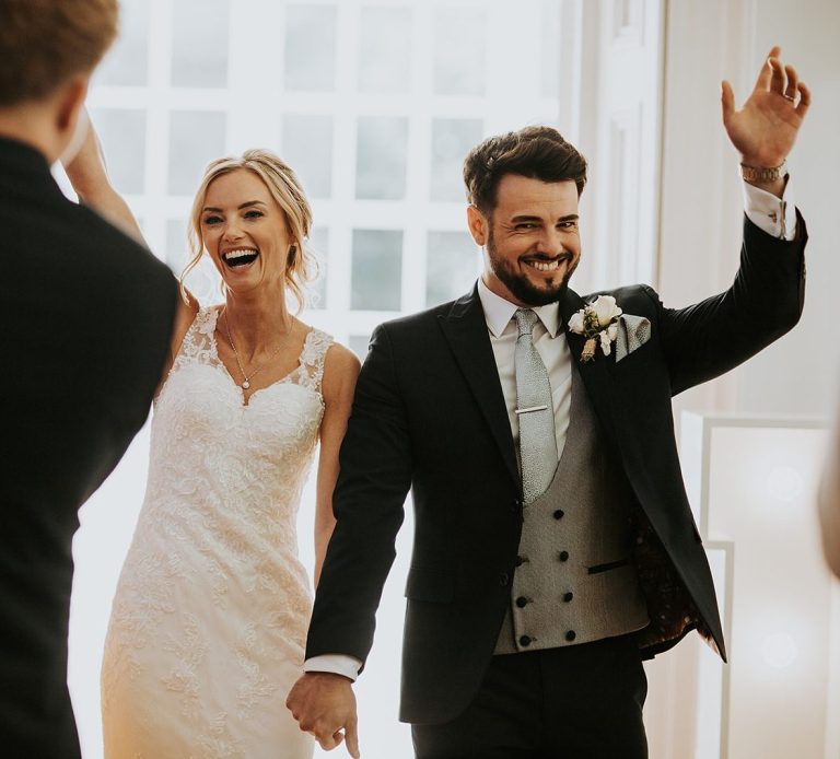 Happy couple holding hands and celebrating tying the knot after a ceremony with Molly’s Ceremonies in the North West